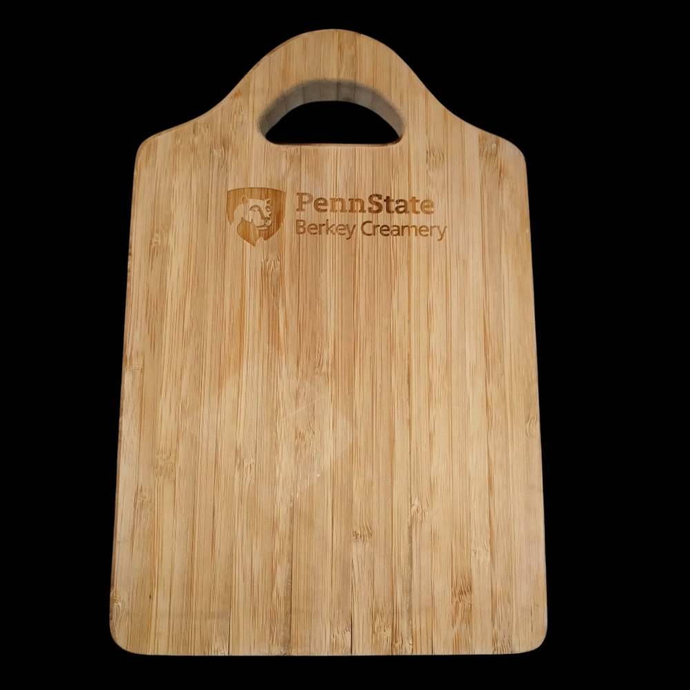 This is a Penn State Berkey Creamery branded bamboo cutting board 7×11in.